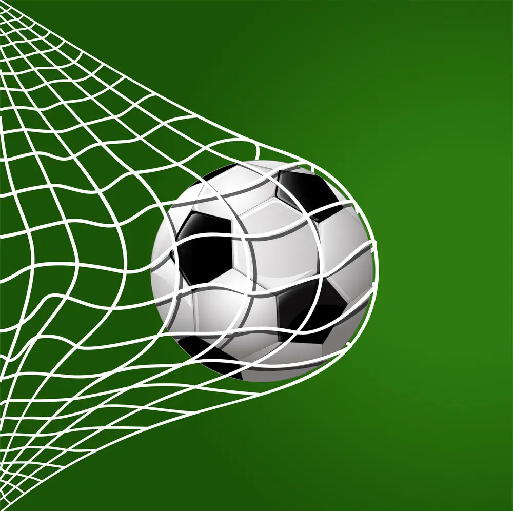 football hitting goal net on green background